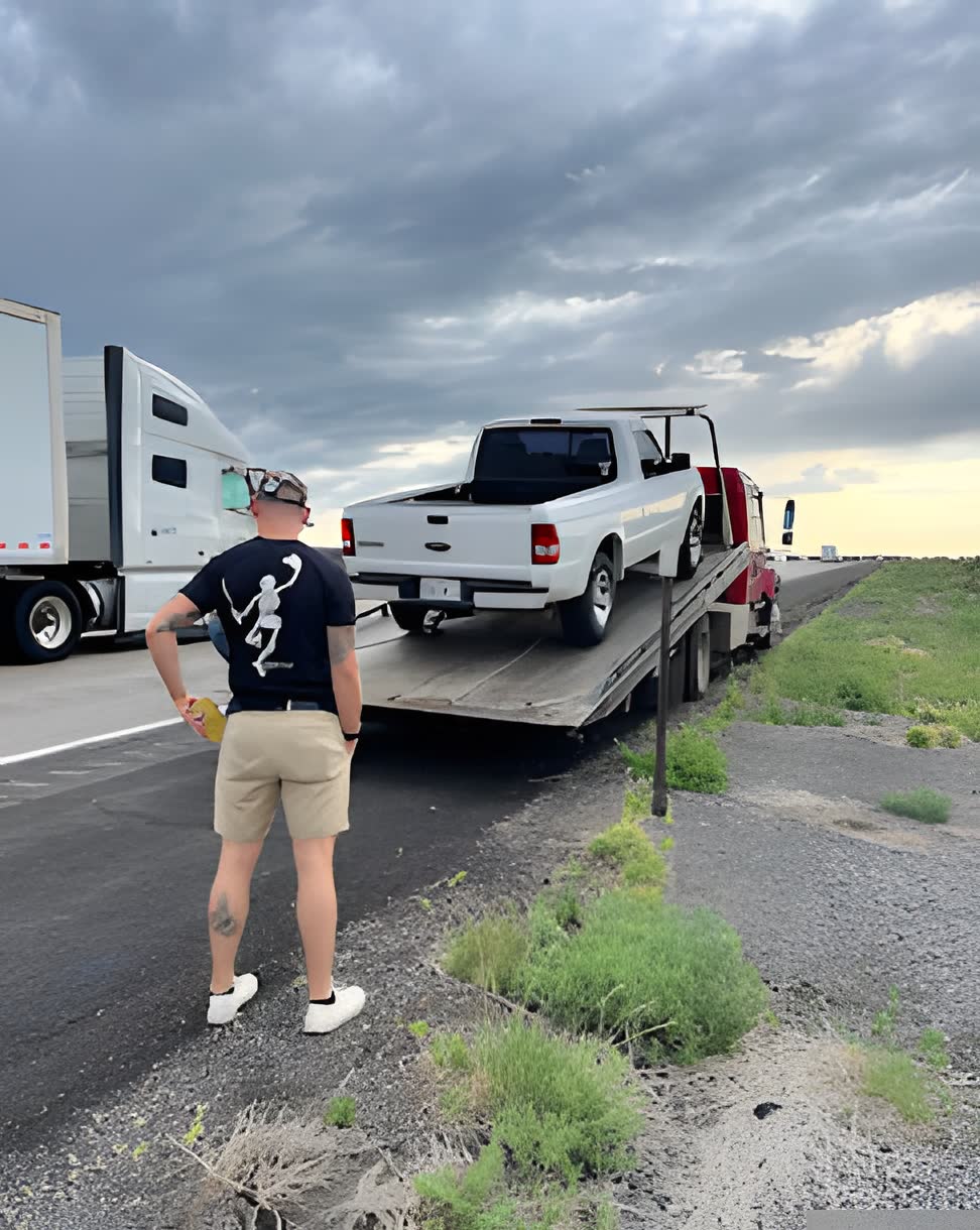 Pickup being towed at sunset on the I-40 corridor